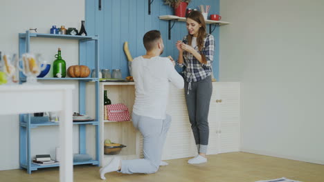 una pareja celebrando en la cocina.