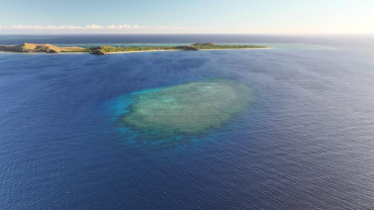 Coral Reefs On Tropical Island With Crystal Clear Seas At Mana Island In Mamanuca Islands, Fiji. Aerial Drone Shot