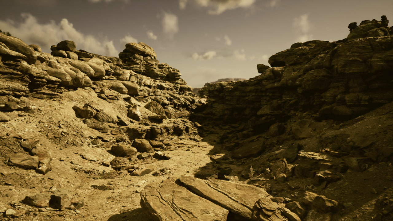 Sunlit rugged desert scenery vast rocky canyon under warm sky