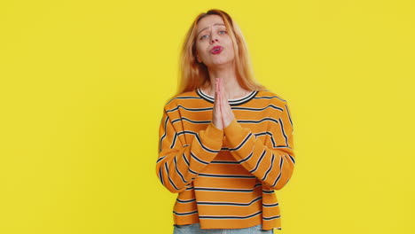 young adult woman praying making wish asking hopeful help begging apology meditation imploring