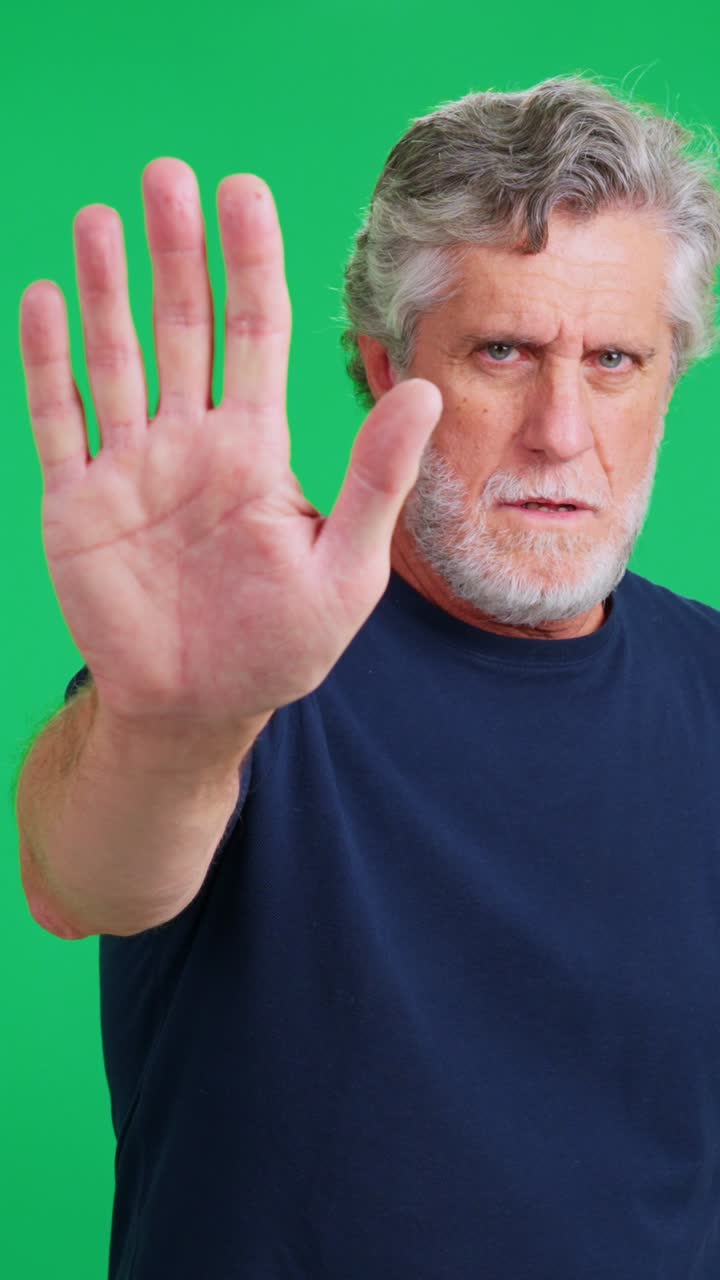 Serious Older Man Gesturing Stop Against Green Screen