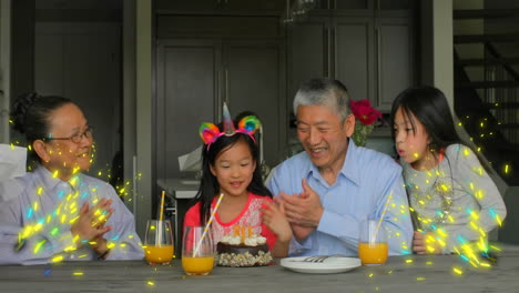 family enjoying breakfast with orange juice, sparkles animation surrounding them