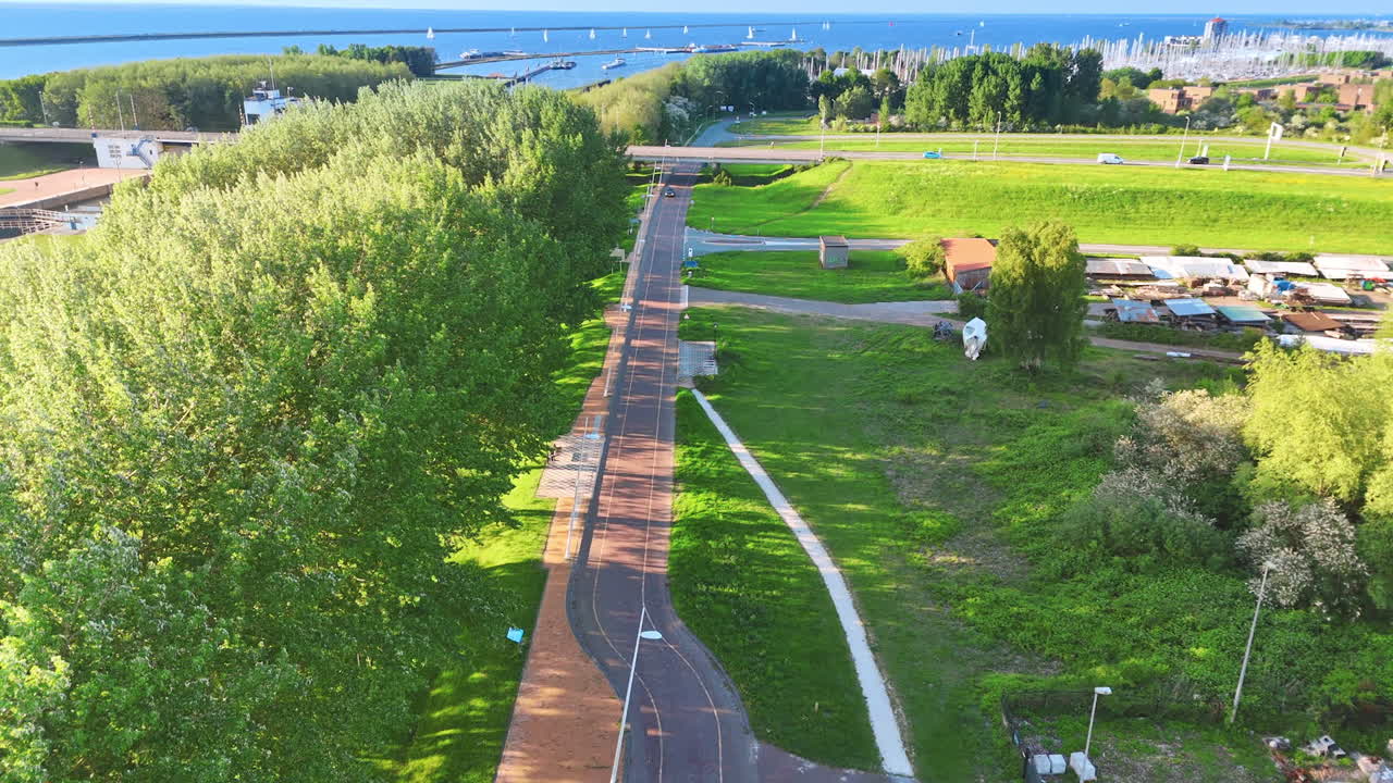 Beautiful park landscape in Netherlands. A serene park in the Netherlands features lush greenery, walking paths, and a peaceful waterfront view during daylight