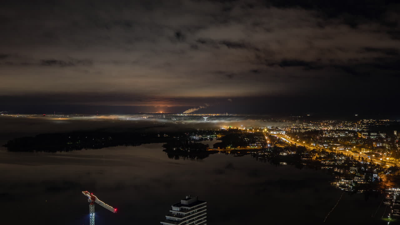 Night Cityscape with Construction Crane and Fog