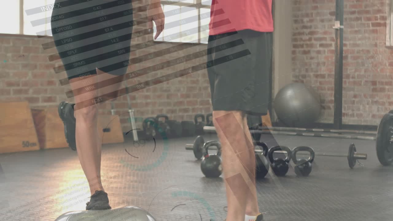 Male trainer signaling start guiding female client into one-leg hold near kettlebells for fitness