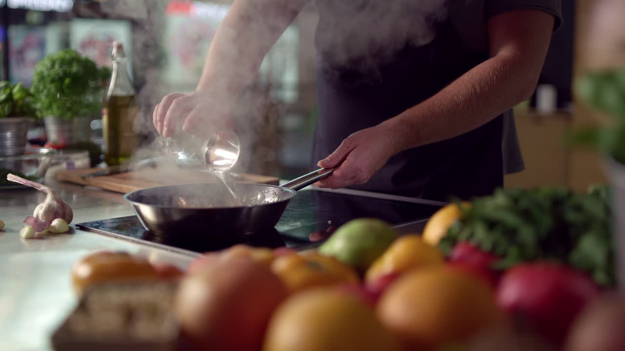 Cook adds alcohol to skillet and lights it