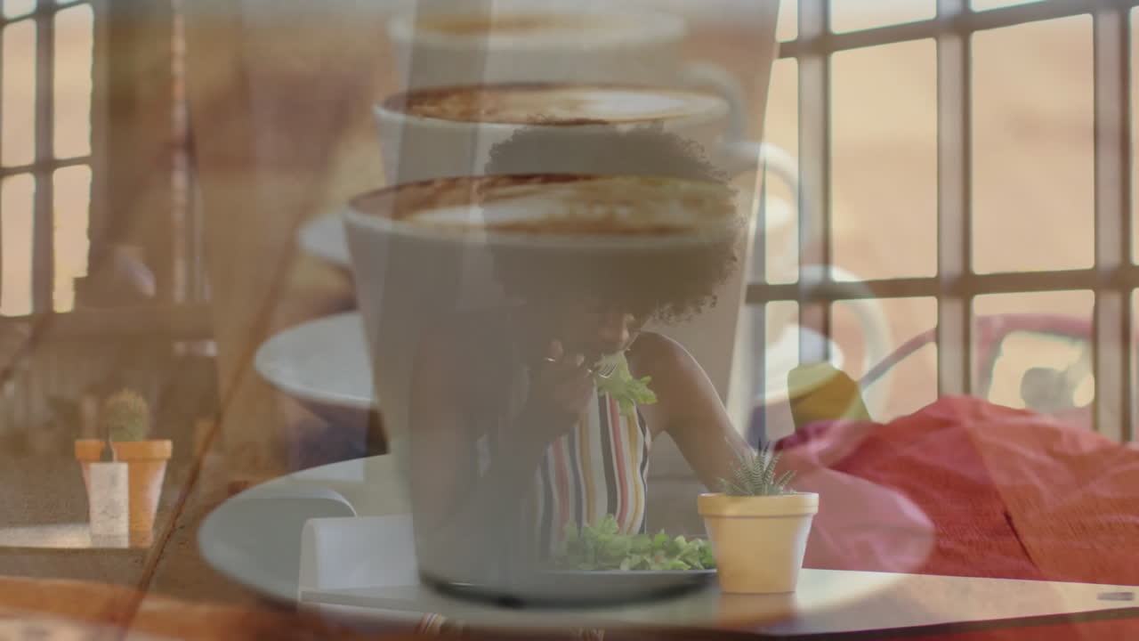 Female diner eating green salad at cafe table, showing coffee cup overlay highlighting health theme