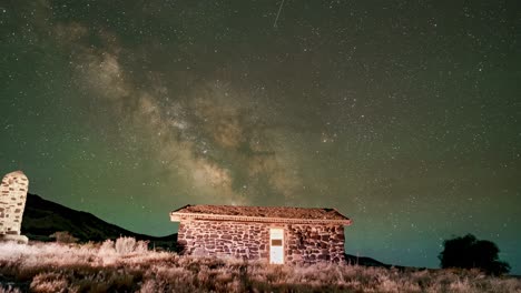 Twilight-fades-to-nighttime-as-the-Milky-Way-crosses-the-sky-over-a-vintage-cabin---time-lapse