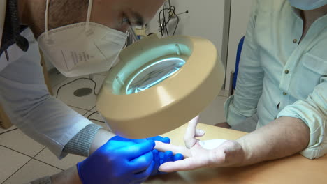 doctor examining patient's finger
