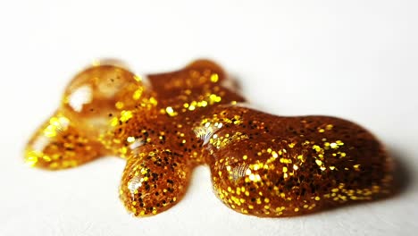 golden wet glitter on a white paper