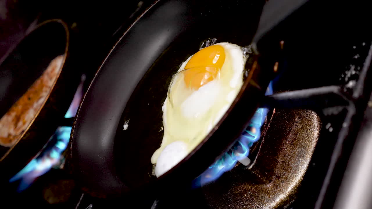 Eggs and sausage cooking on a stove