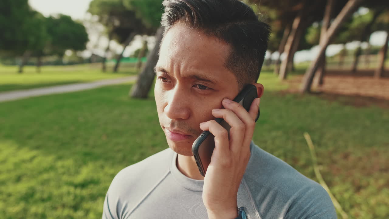 Man talking on phone in the park