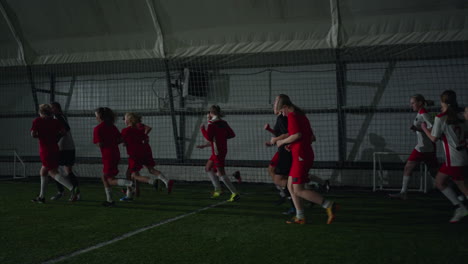 girls soccer team practicing indoors