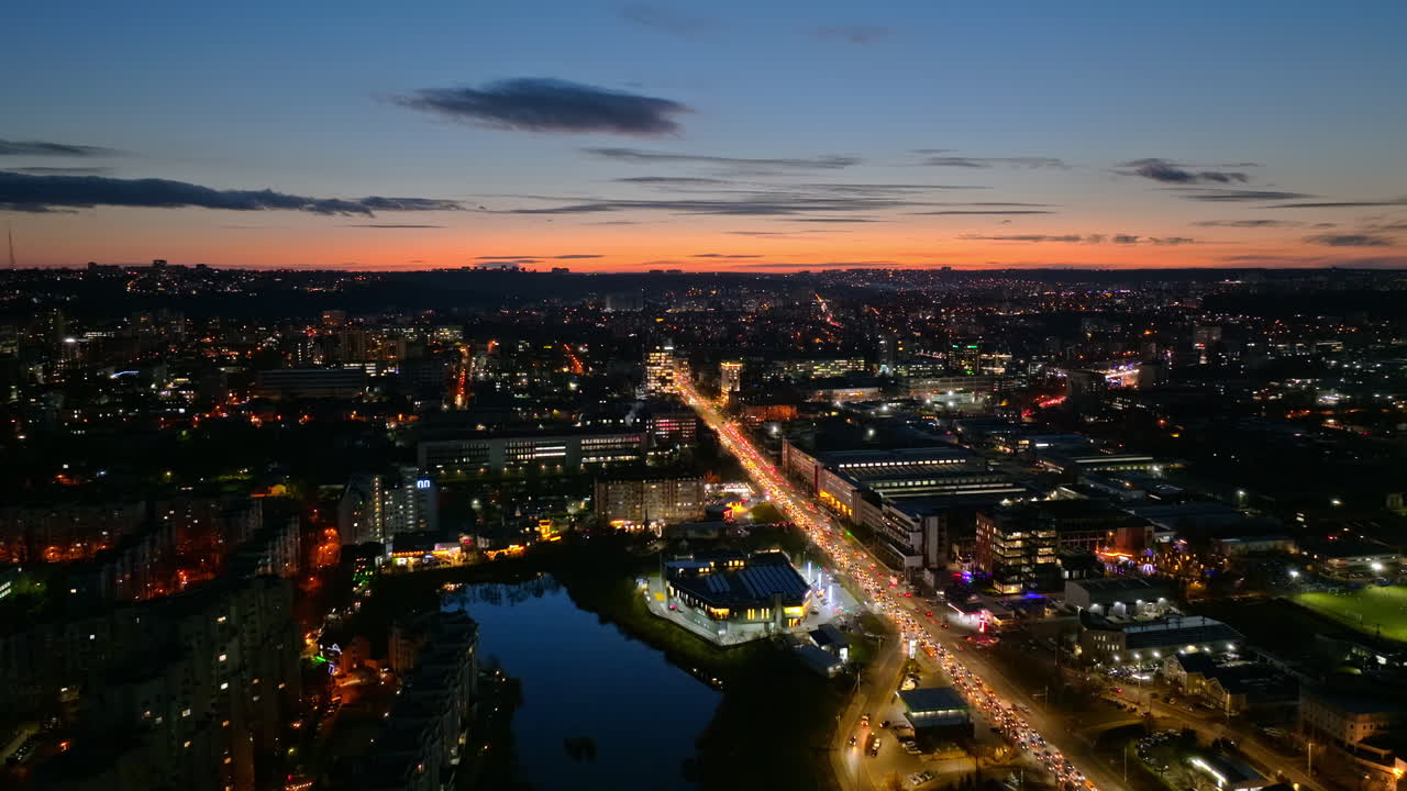 Aerial drone view of cars in traffic at a roundabout in Chisinau, Moldova at sunset