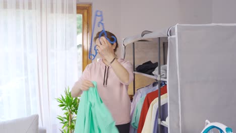 housewife ironing clothes in the closet.