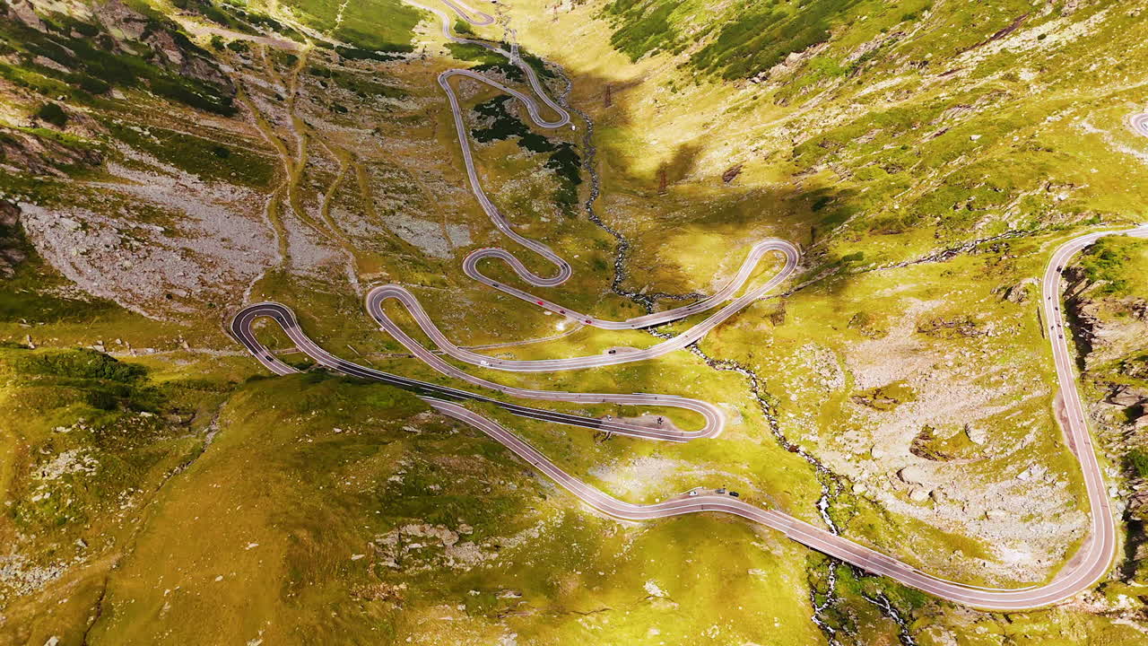 Clouds shade the valley with famous Transfagarash highway. Drone footage over the landmark in the Carpathian Mountains, Romania