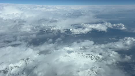 POV-of-The-Alps-Mountains-with-the-snowed-peaks,-shot-from-an-airplane-cockpit-in-a-real-time-flight-bound-Turin-Airport