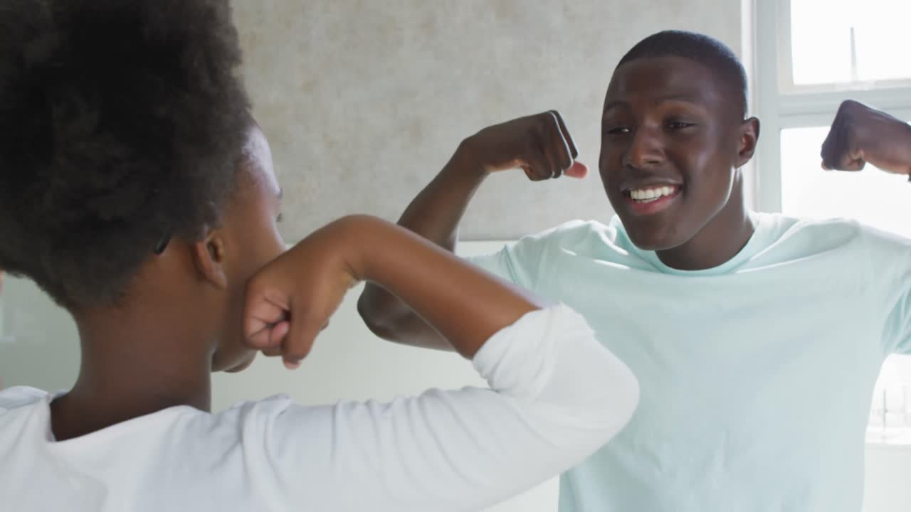 Video of african american father and daughter brushing teeth