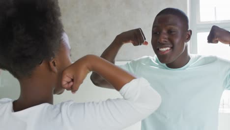 video of african american father and daughter brushing teeth