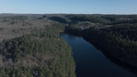 Tranquil-River-Surrounded-With-Lush-Trees-During-Winter-In-Quebec,-Canada