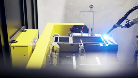 panning large shot of an automated welding machine, welding steel in a industry