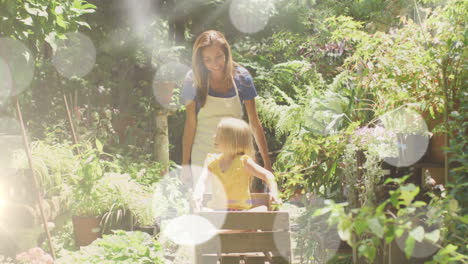 spots of light against caucasian mother carrying her daughter in the garden cartin the garden