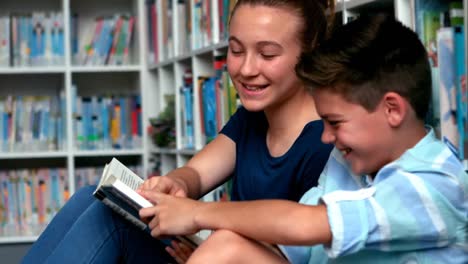 school kids reading books in library at school