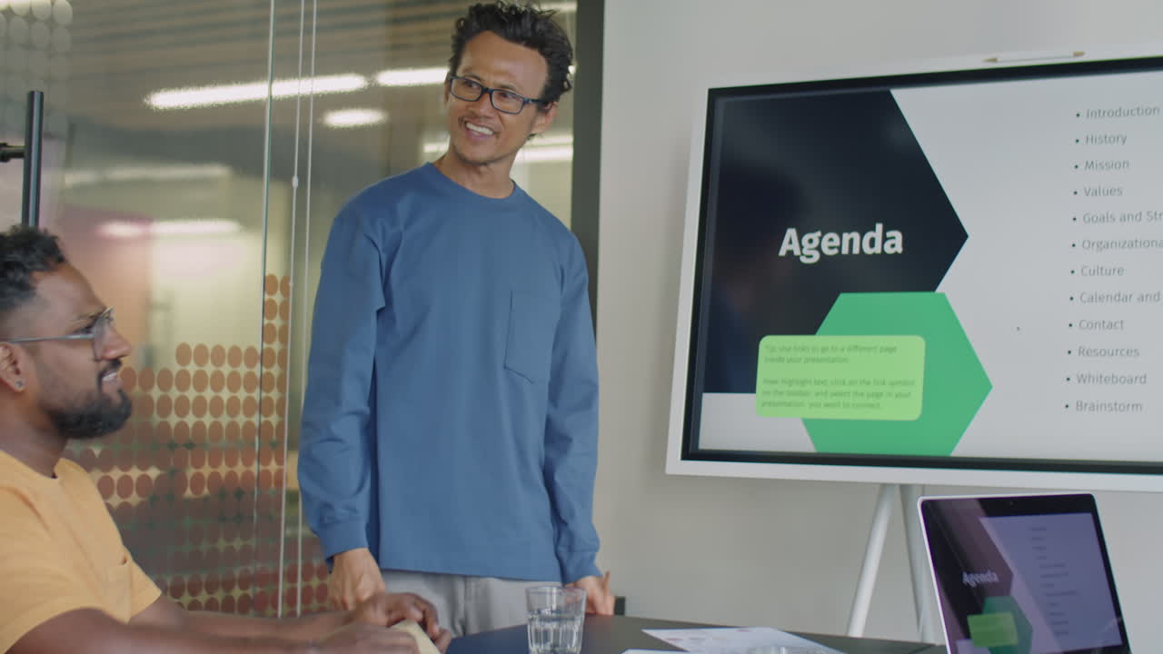 Asian Man Giving Presentation on Business Meeting in Office
