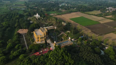 high-altitude aerial shot of murshidabad monuments, with the palace and mosque set against a serene backdrop.