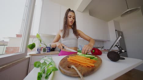 young woman preparing vegetables in a kitchen for a healthy meal
