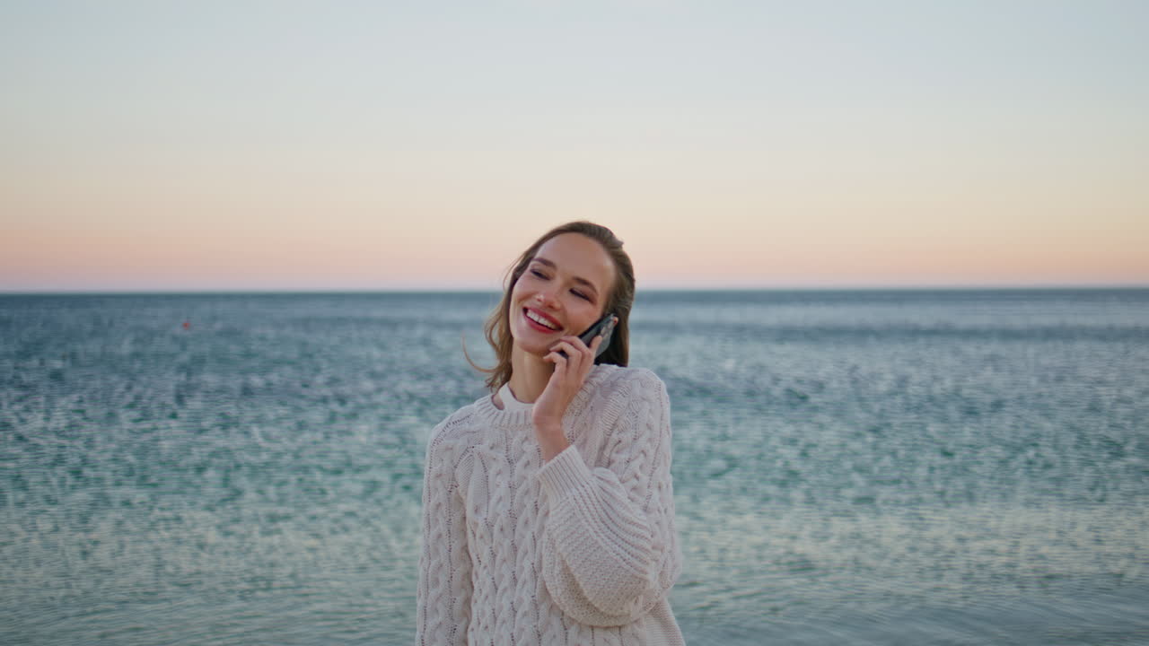 Lady talking smartphone ocean horizon closeup. Smiling woman calling sunset