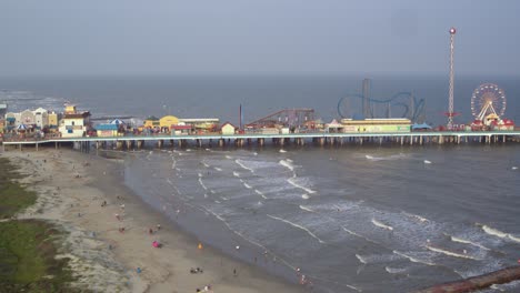 Drone-view-of-the-Pleasure-Pier-and-Galveston-Beach-in-Galveston,-Texas