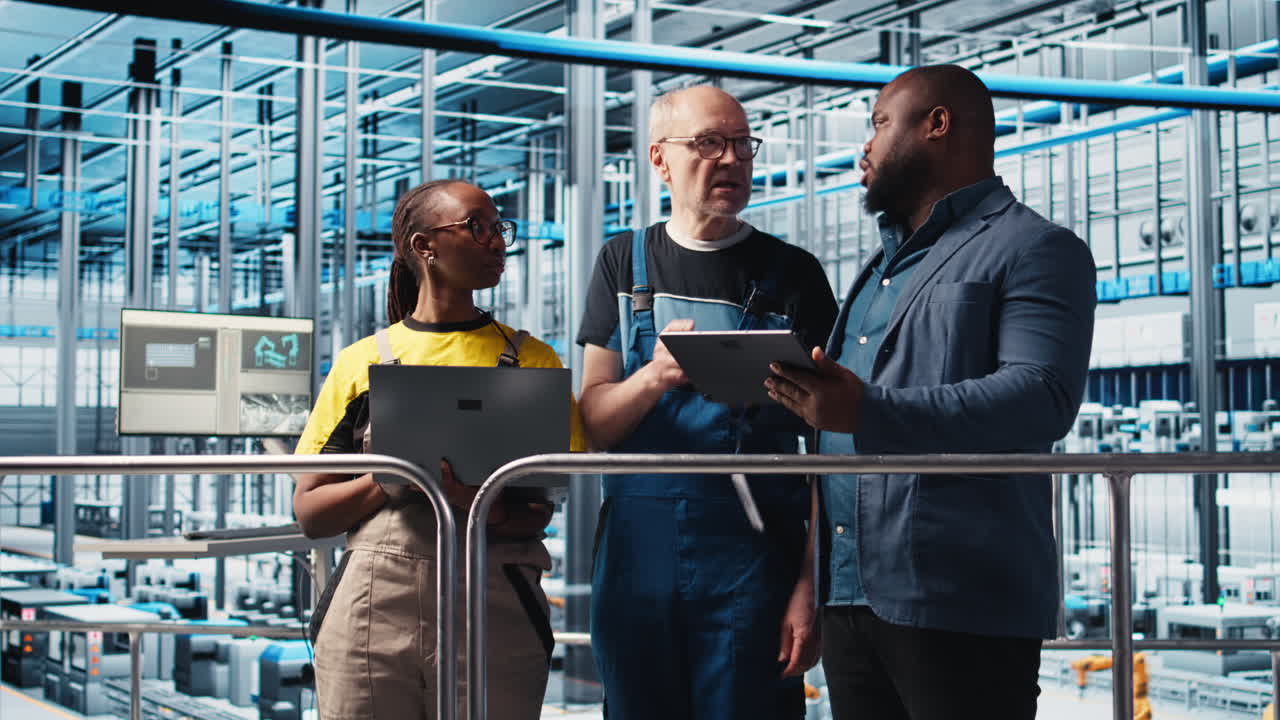Smart factory engineering team colleagues implement automated workflows