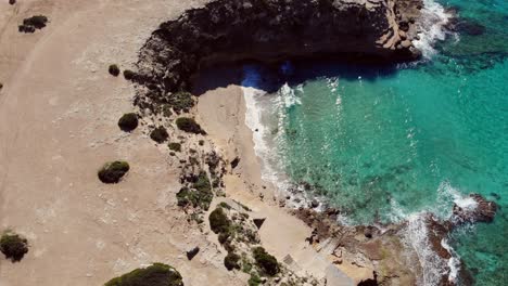 drone facing down filming coast on ibiza