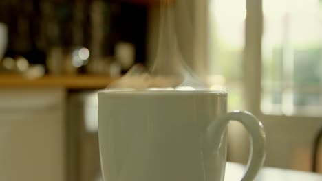primer plano de una taza de café en la mesa de comedor en la cocina de una casa cómoda 4k