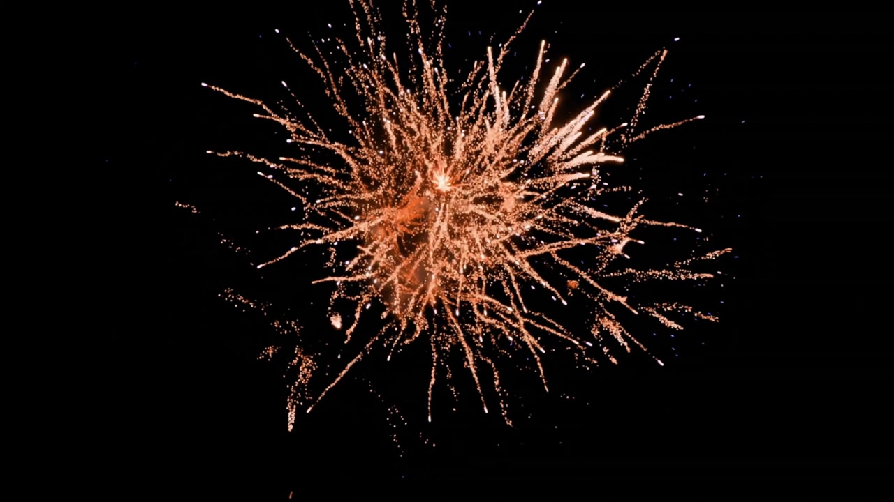 Fireworks animation with golden sparks exploding against black background