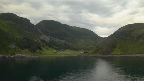 Scenic-View-Of-Lake-With-Mountains-In-Background-Reflected-In-Water,-Måløy,-Vestland-County,-Norway---aerial-drone-shot