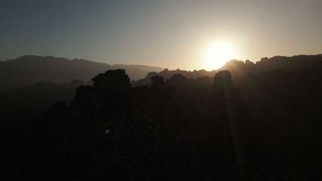 sunrise over silhouetted mountains in the desert of cederberg, south africa