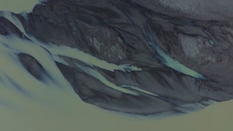 Aerial-top-down-shot-showing-river-delta-with-different-pattern-and-texture-in-Iceland