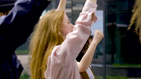 ginger woman holding there is no planet b placard on a protest with more people