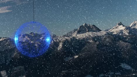 Animation-of-snow-falling-over-blue-christmas-bauble-and-winter-mountain-background