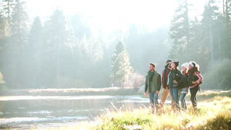 A-group-of-friends-hiking-near-lake-stop-to-admire-the-view