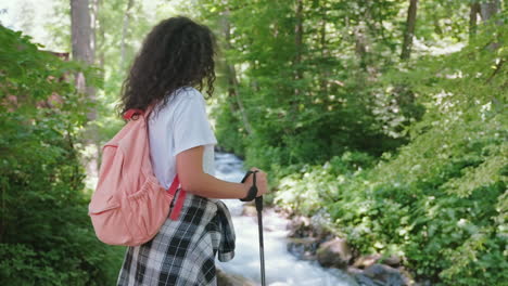 woman hiking in a forest stream