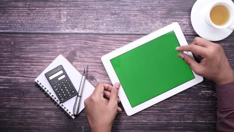 young man working on digital tablet at office desk