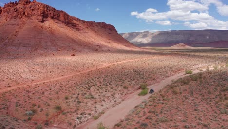 aerial of a dune buggy riding through desert terrain