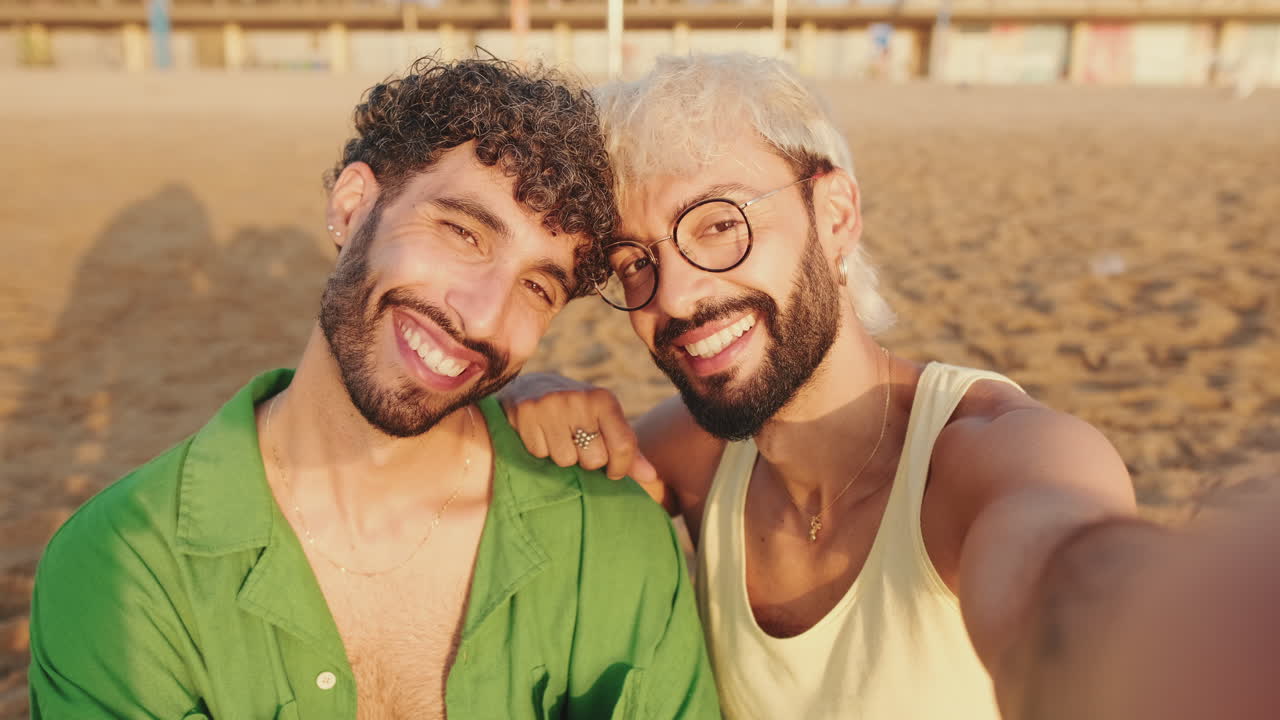Happy Gay Couple Taking a Selfie on the Beach