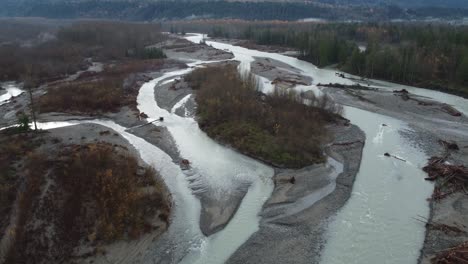 powerful river flooded vast to sides in canada forestry landscape, aerial drone view