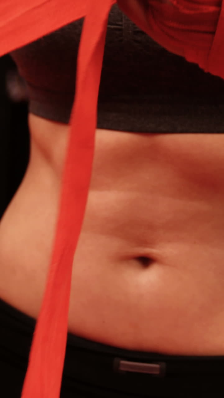 Female boxer wearing red strap on wrist