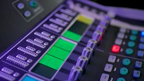 A-detailed-close-up-shot-of-an-audio-mixer,-showcasing-the-intricate-knobs,-sliders,-and-buttons