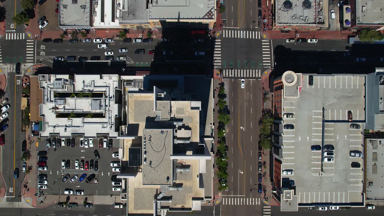 Vista aérea de drone diretamente sobre a arquitetura do centro de San Diego e as ruas urbanas ao redor.